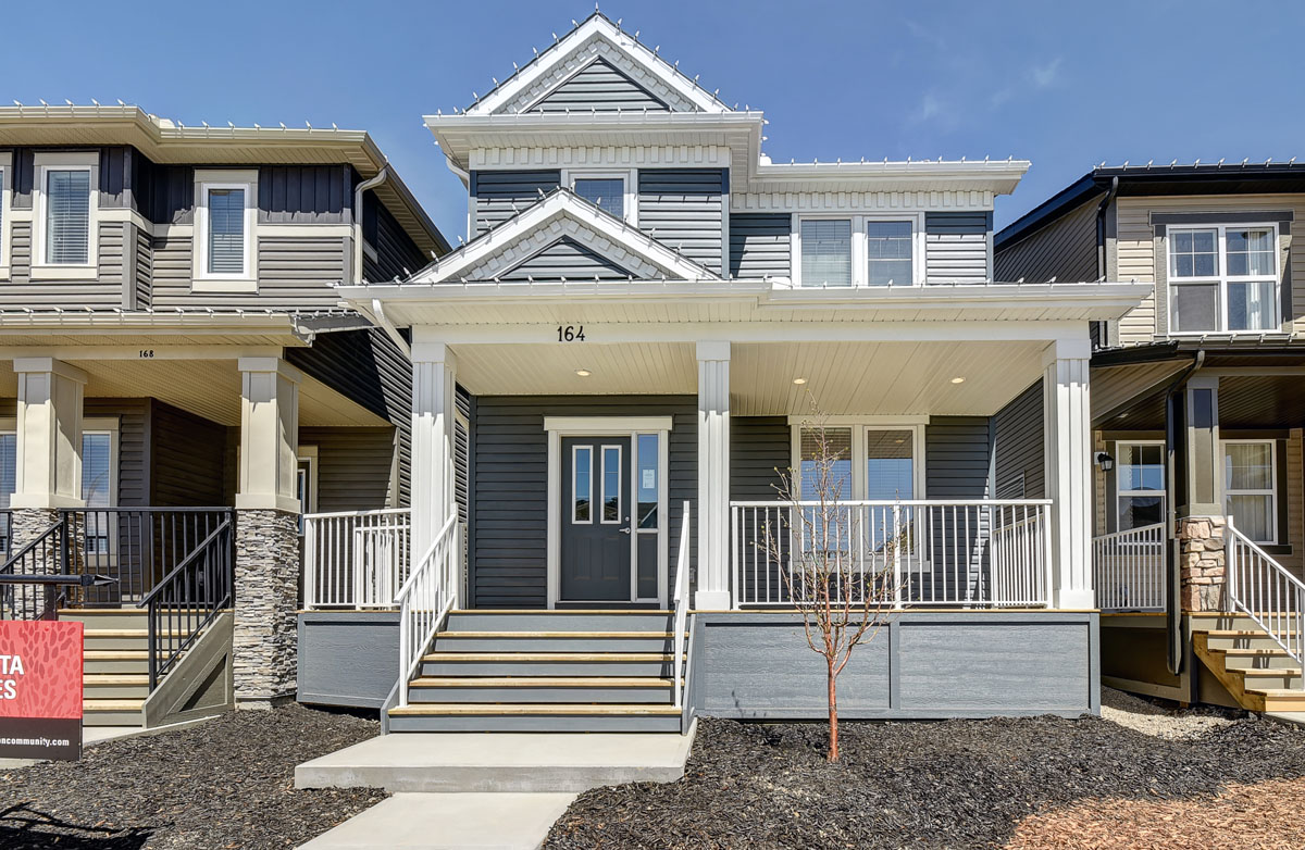 Front exterior of the Banbury ll model home from Nuvista Homes with blue siding and white accents.