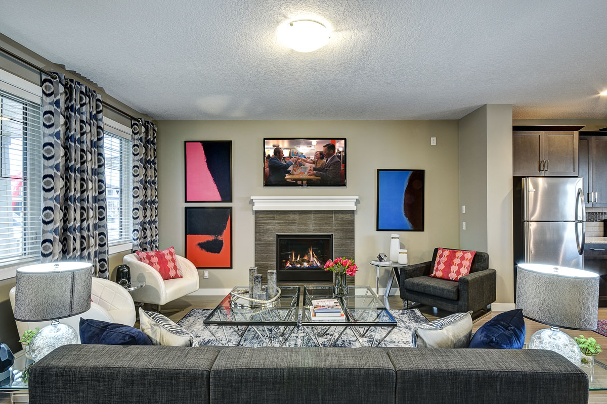 Front view of the living room with lit fire place in the Banbury II Model home.