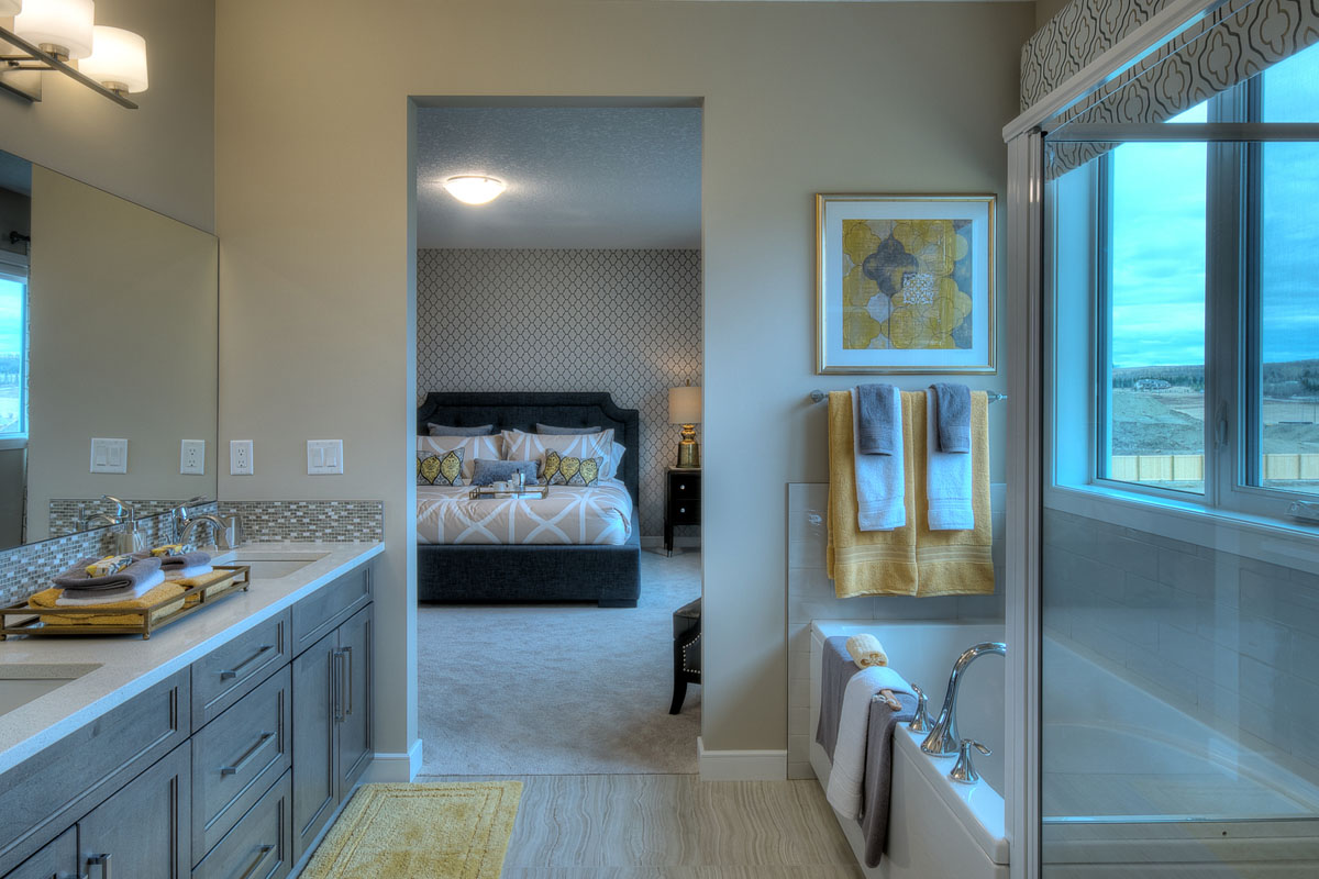 Ensuite bathroom facing the bedroom next to the soaker tub and his and hers sinks in the Bentley II model home.