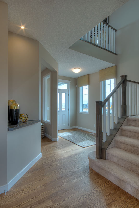 Main foyer in the Bentley II model home next to staircase.