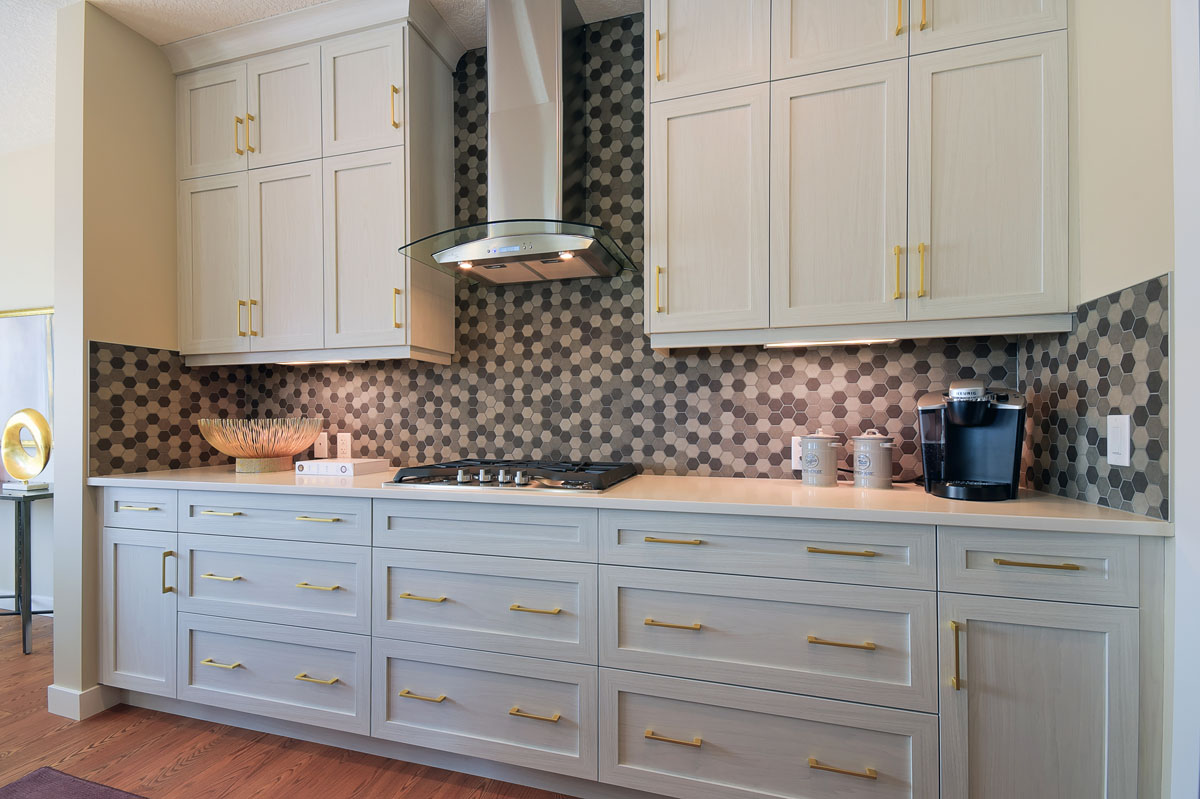Kitchen cabinets with gas stove top and gold handels in the Brentwood model home.