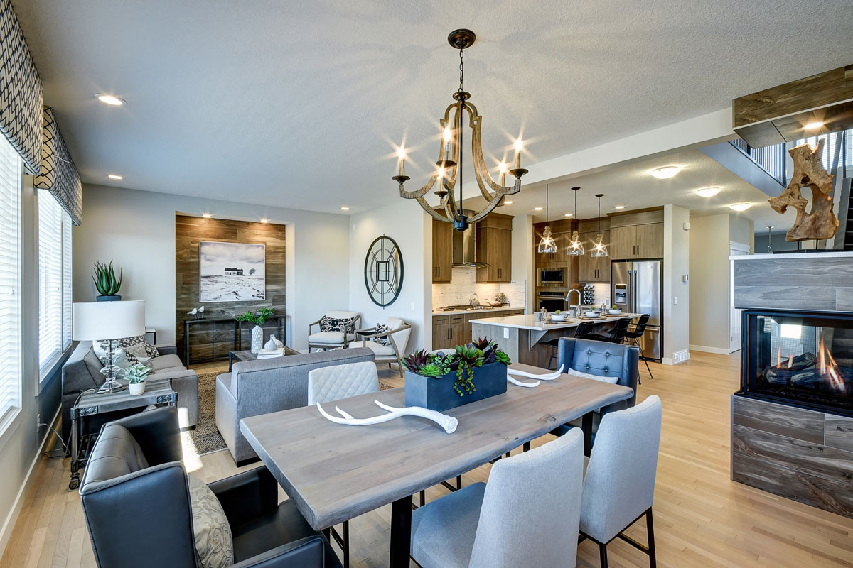 Dinning room with grey wooden table and modern style chairs in the Hamilton Wil model home.