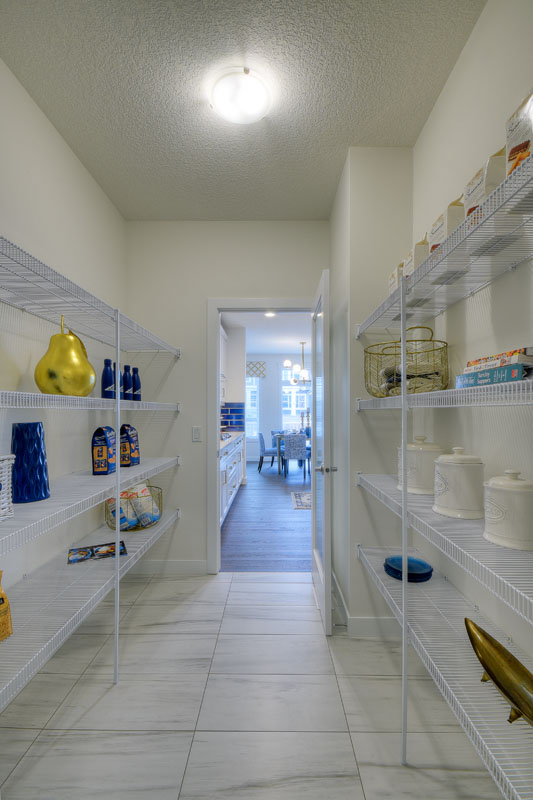Pantry with white wire shelving and cooking supplies in the Kingsley Cre