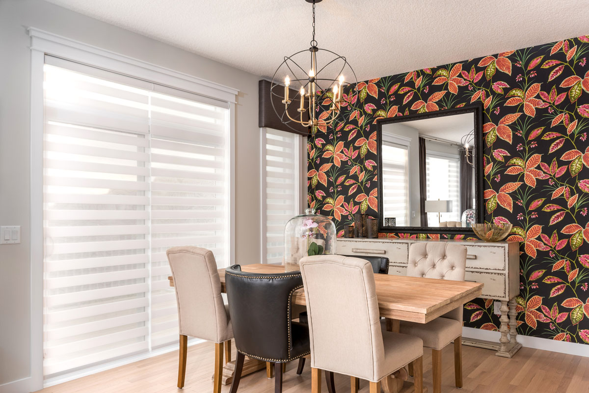 Dinning room with black and pink floral print accent wall and dinning room table in the Kingston model home.