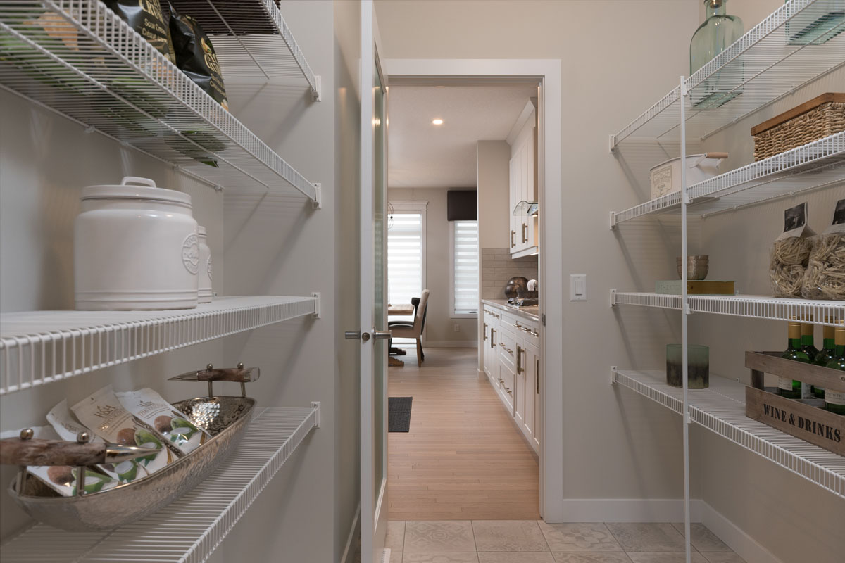 Pantry with white wire shevling and baking supplies in the Kingston model home.