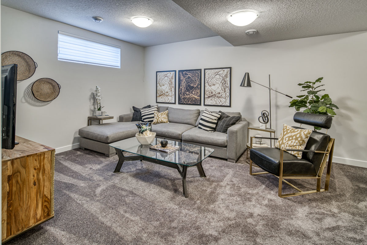 Facing the grey sectional and black leather chair in the Lakeview model home.