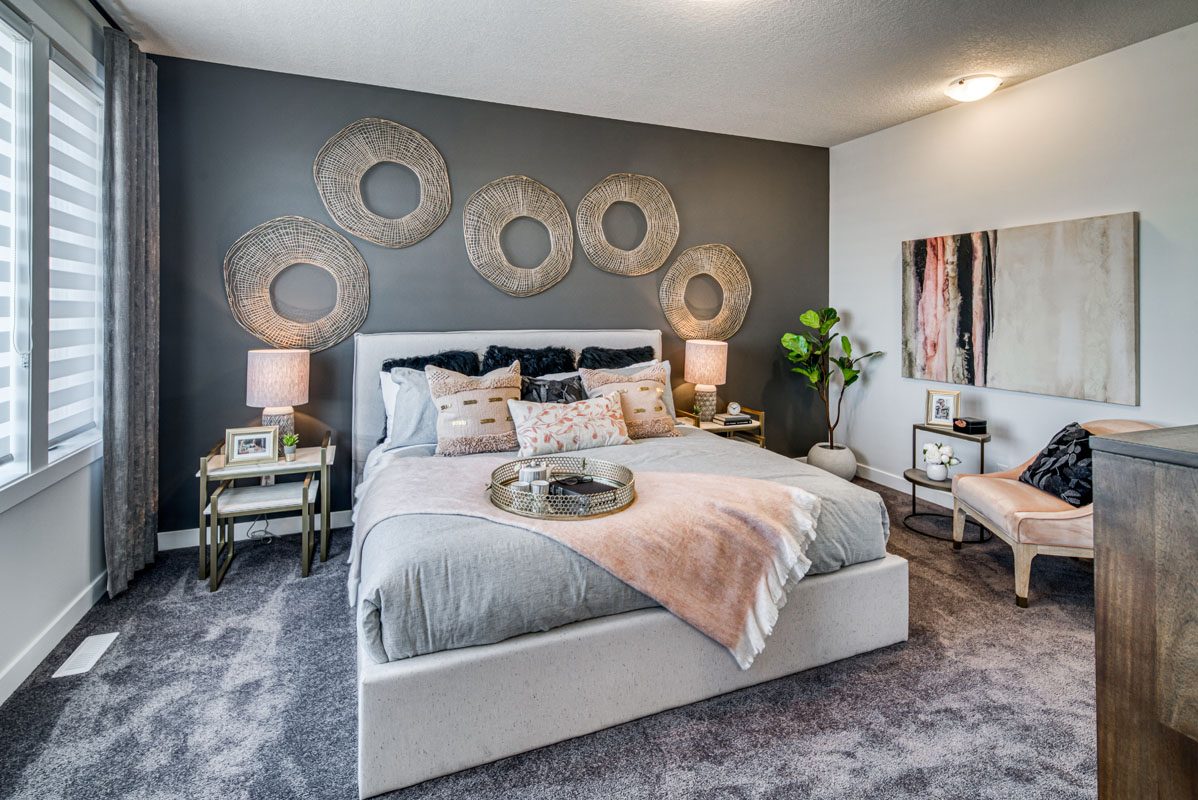 Master bedroom with grey accent wall and grey shag carpet in the Lakeview model home.