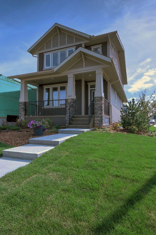 Front exterior of the Leyton model home with large front yard and paved walkway.