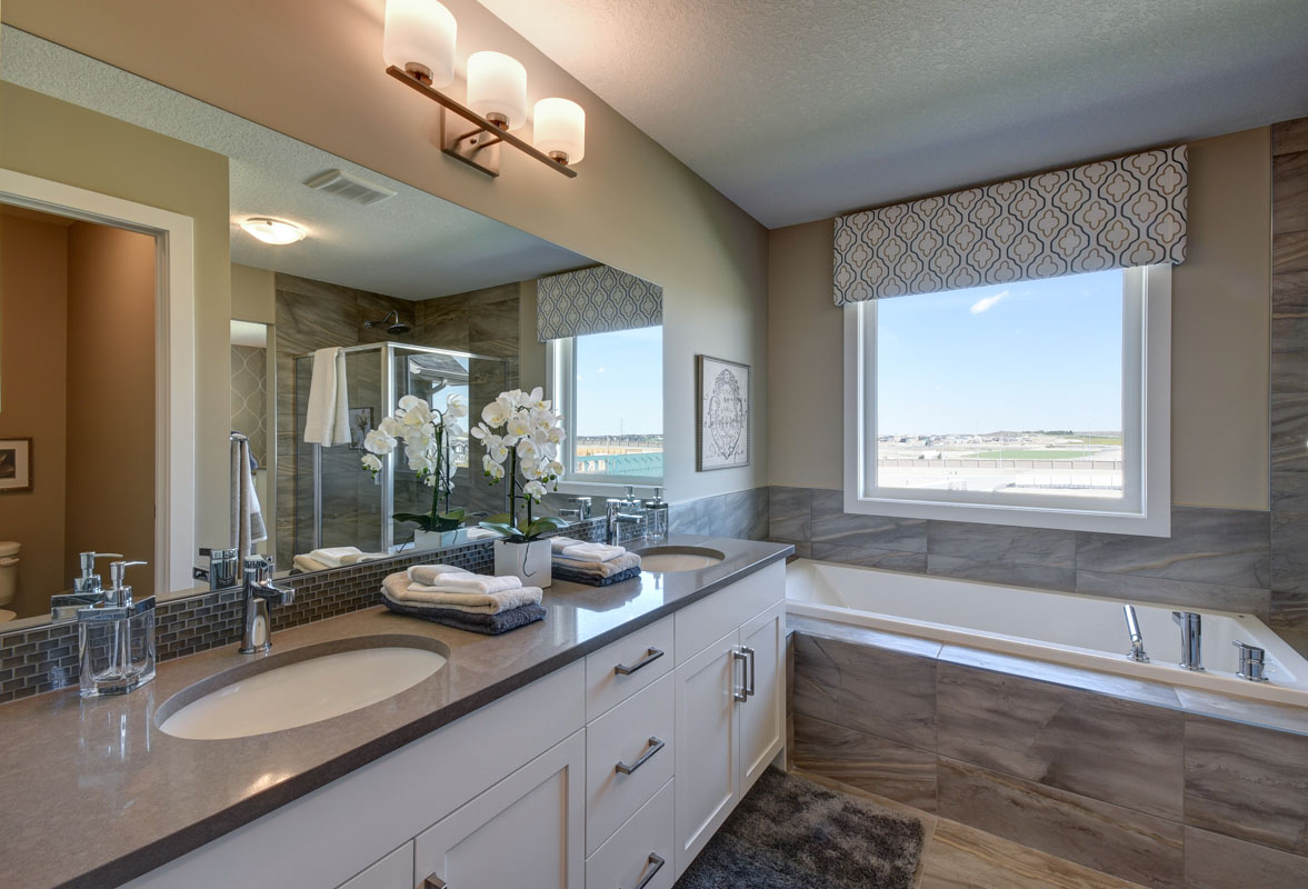 Ensuite bathroom of the Rosewood model home with his and hers vanity next to large soaker tub.